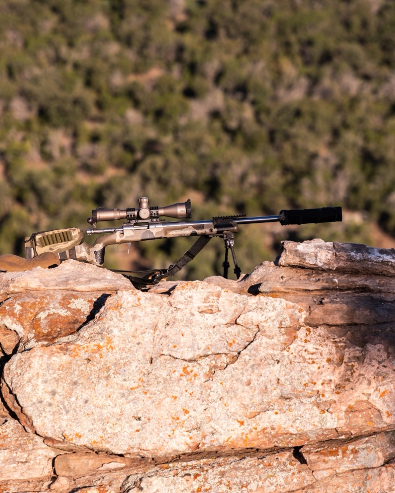 A rifle staged on the rock ledge