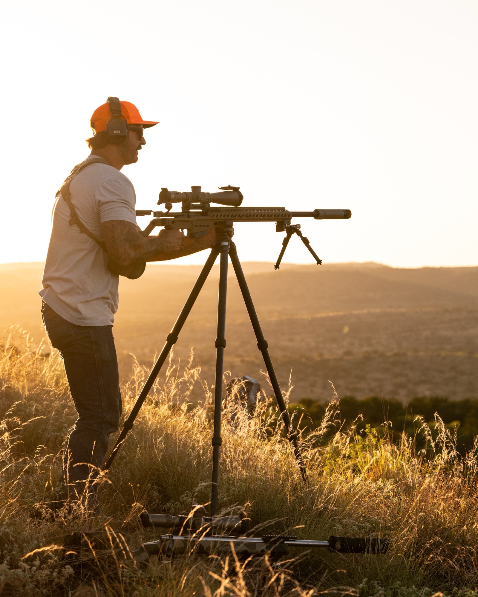 A member shooting off a tripod at sunset